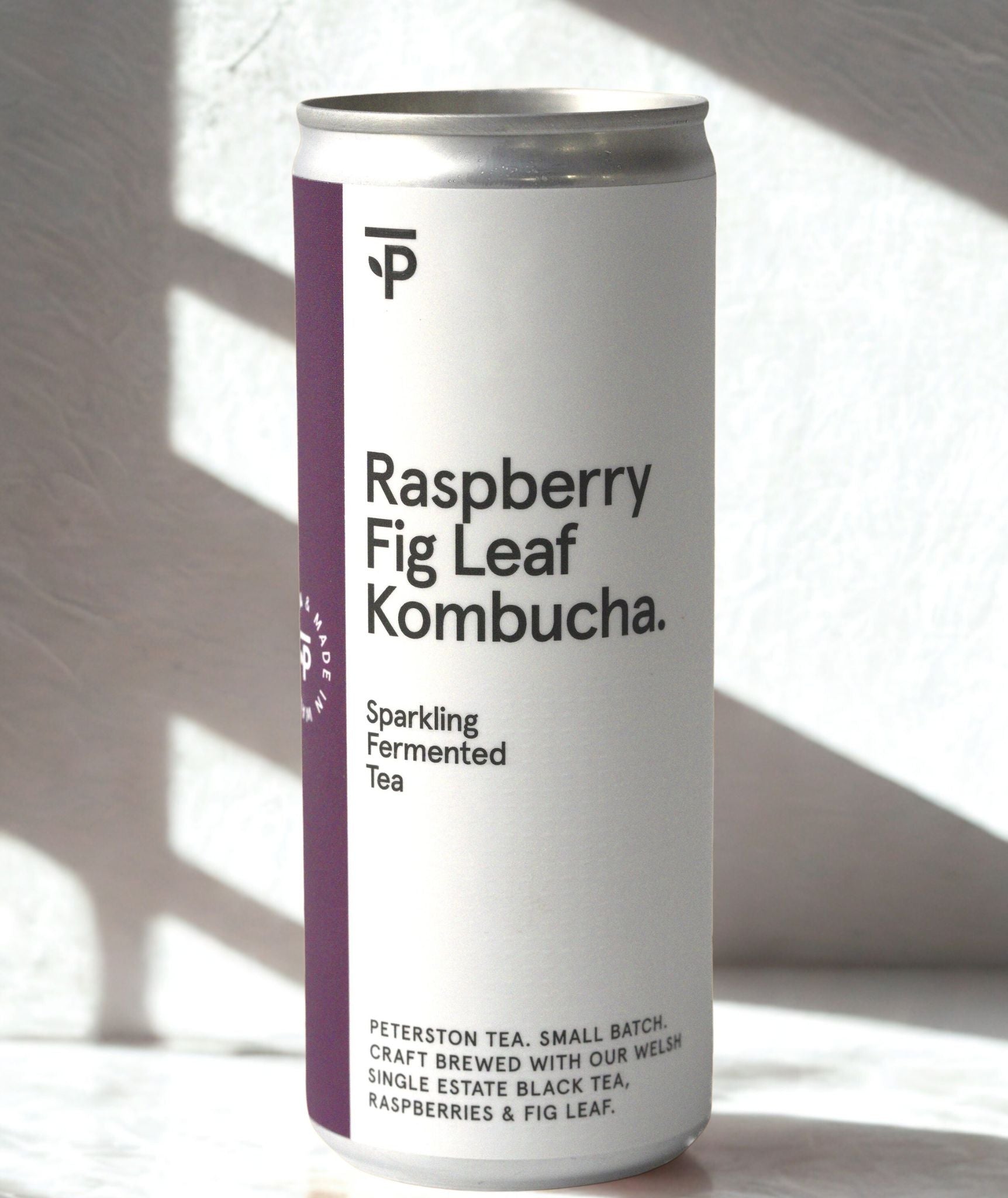 Can of organic Raspberry Fig Leaf Kombucha on a light background
